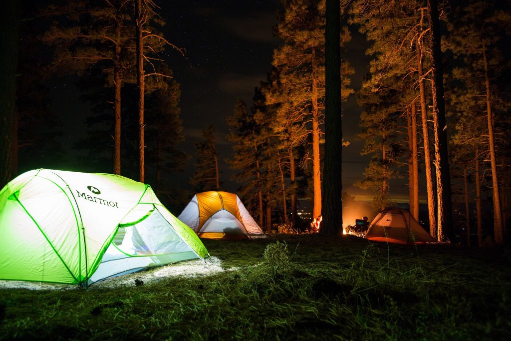 three tents lit up at night